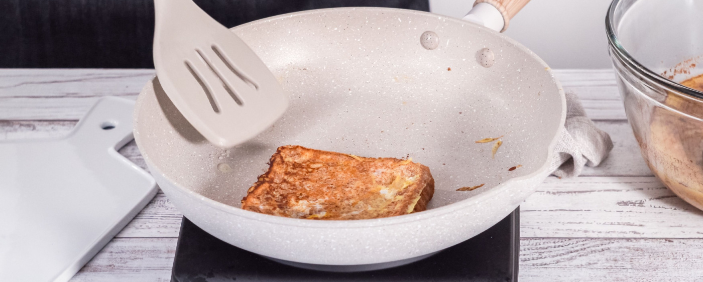 French toast being toasted in a skillet.