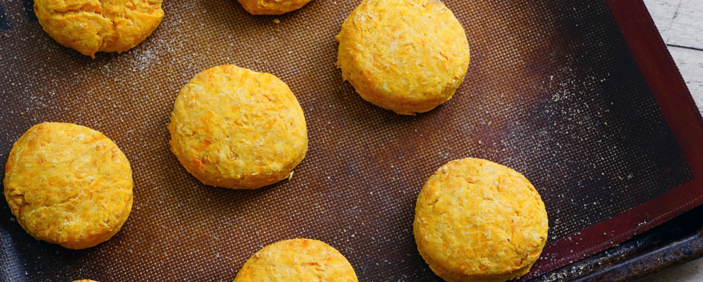 Sweet potatoes baking on a sheet pan for sweet potato biscuit