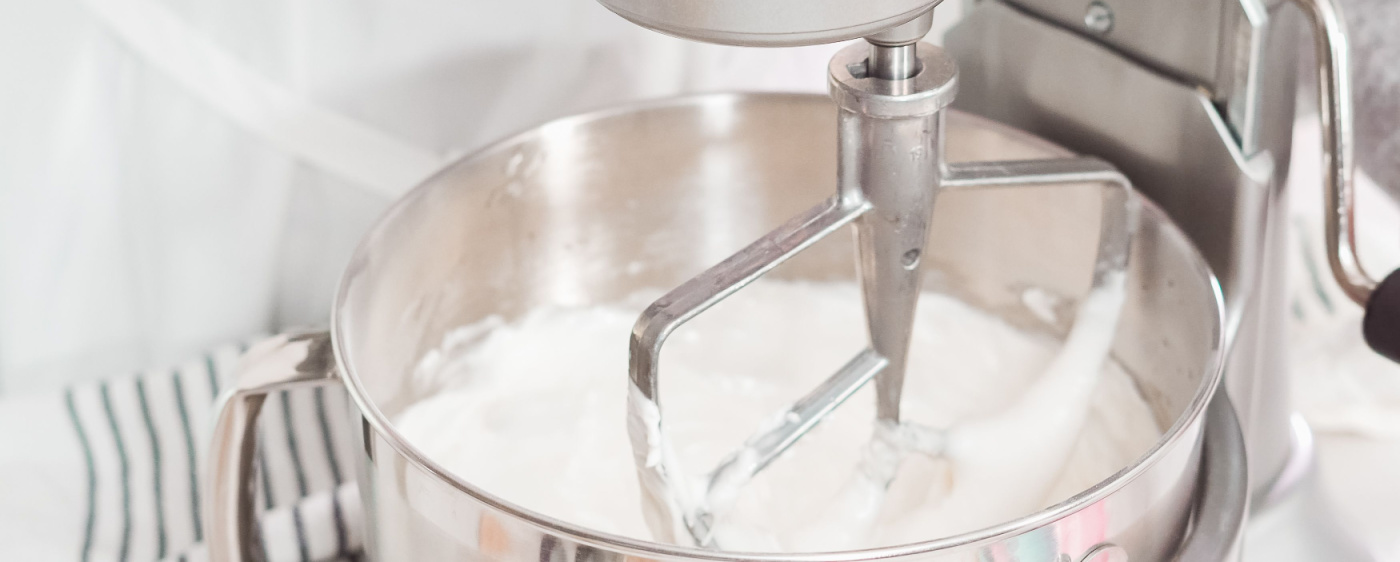 Icing being mixed in a stand mixer