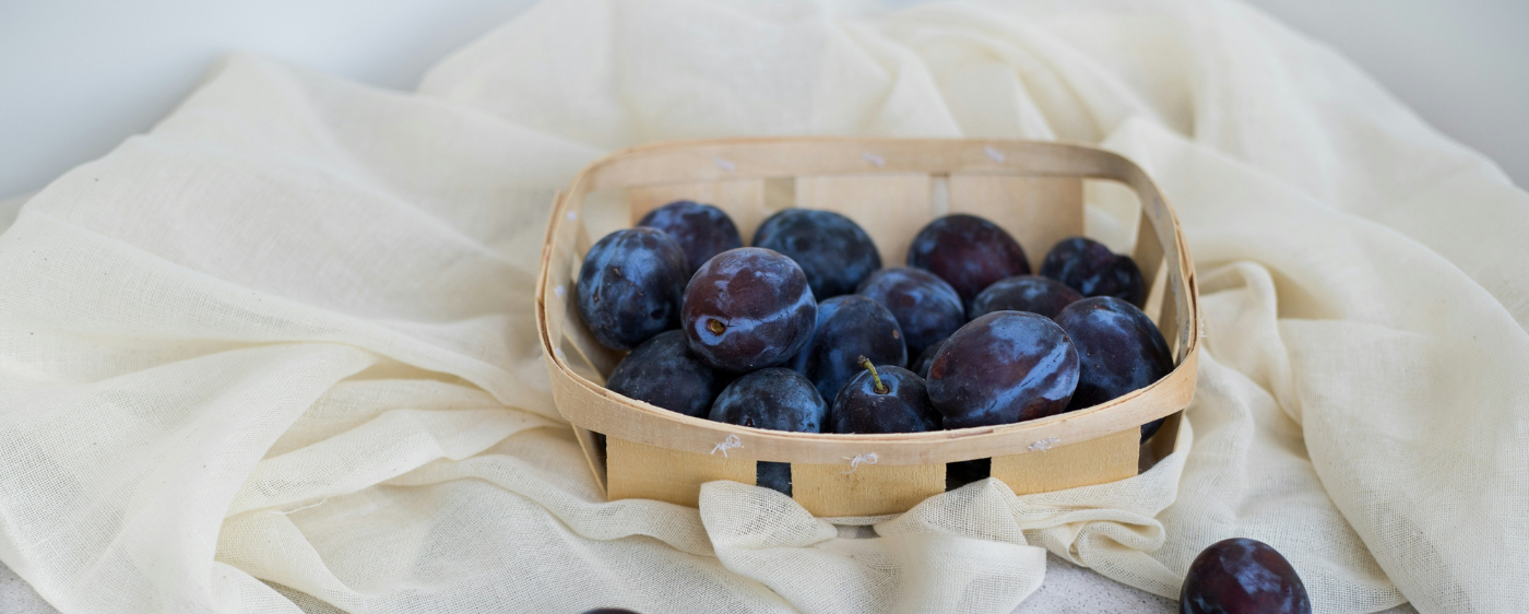 Prunes for Prune Cake sitting in a basket.