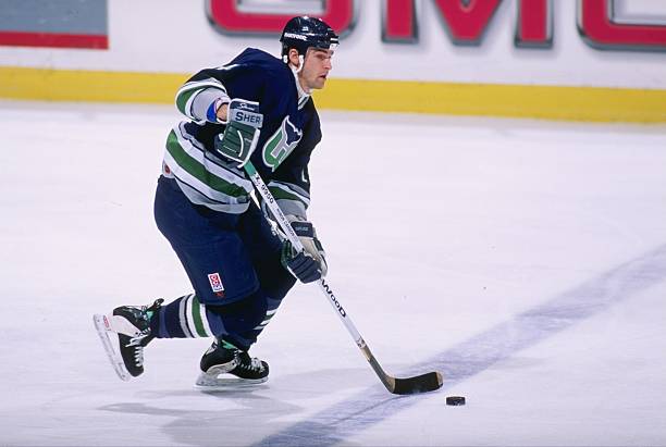 Defenseman Kevin Haller of the Hartford Whalers moves the puck during a game against the New Jersey Devils at the Continental Airlines Arena in East...