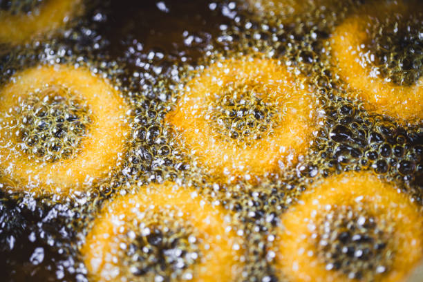 frying foods macrophotography - frying onion rings stock pictures, royalty-free photos & images