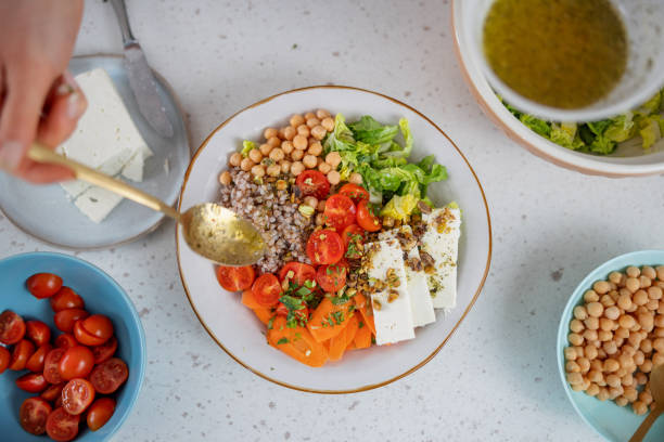 aerial view of the preparation of a colorful healthy salad - greek chickpea salad stock pictures, royalty-free photos & images