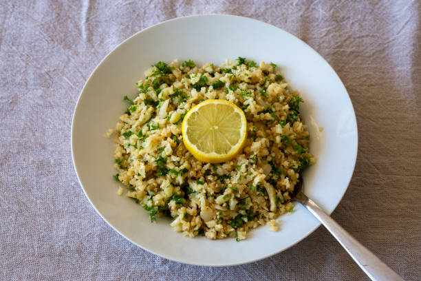 cauliflower rice with finely chopped parsley - lemon-herb rice pilaf stock pictures, royalty-free photos & images