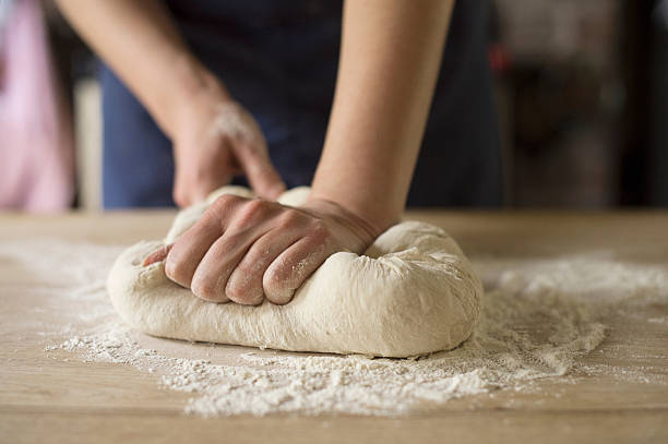 hands kneading bread dough - kneading dough stock pictures, royalty-free photos & images