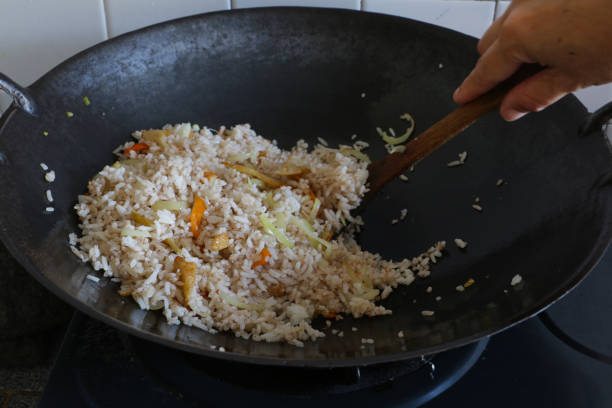 fried rice on wok - wok stock pictures, royalty-free photos & images