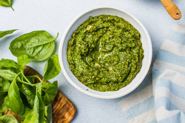 pesto sause and ingredients on white background, copy space - pesto stock pictures, royalty-free photos & images