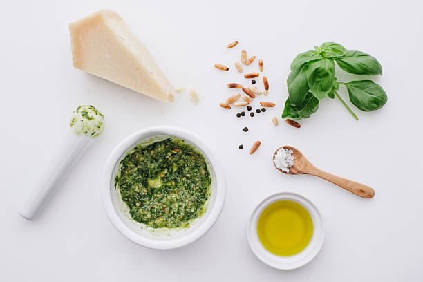 ingredients for pesto on white ground - pesto stock pictures, royalty-free photos & images