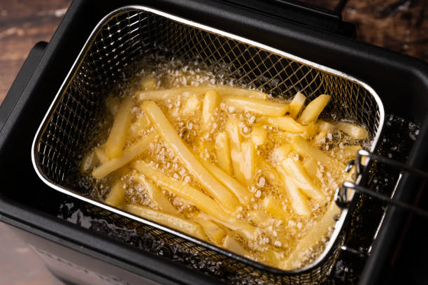 friing potatos in fryier for french fries - making poutine stock pictures, royalty-free photos & images