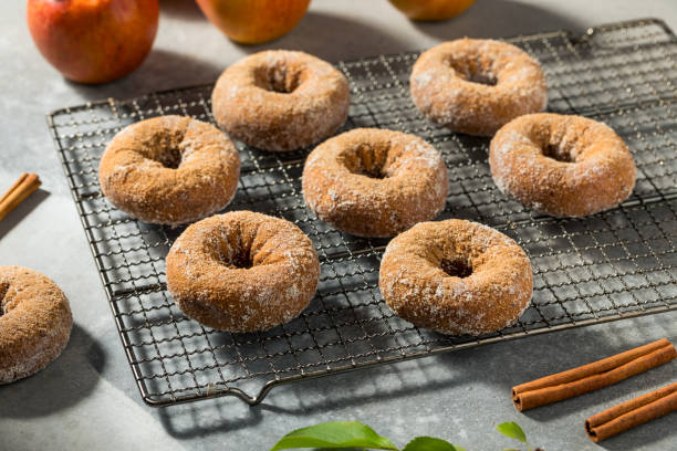 sweet homemade apple cider donuts - baked cinnamon apple cider donuts stock pictures, royalty-free photos & images