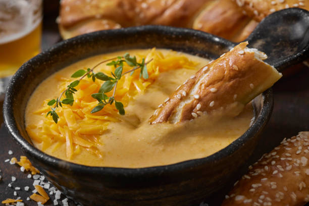 beer cheese sauce with soft pretzels - beer cheese sauce stock pictures, royalty-free photos & images