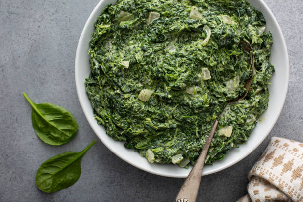 homemade creamed spinach in a bowl - creamed spinach stock pictures, royalty-free photos & images