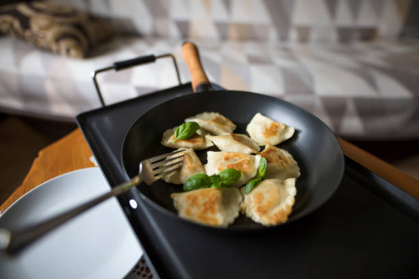 high angle view of dumplings on frying pan (polish pierogies) - pierogi making stock pictures, royalty-free photos & images