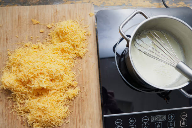 cheddar sauce preparation - making mac and cheese stock pictures, royalty-free photos & images