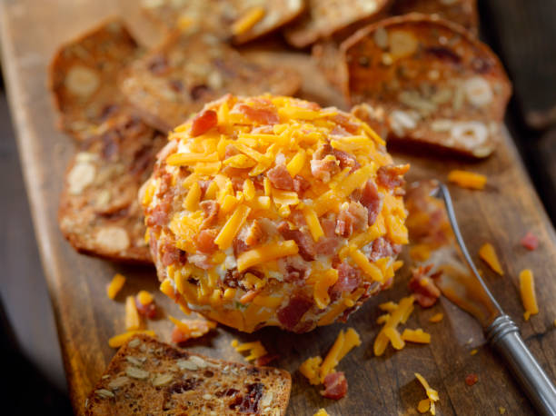 bacon and cheddar cheese ball with crackers - bacon and cheese ball stock pictures, royalty-free photos & images