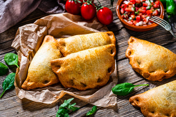 empanada argentina shot on wooden table - beef empanadas stock pictures, royalty-free photos & images