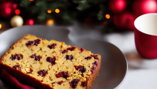 spiced fruitcake with holiday ornaments and cup in background - spiced fruitcake stock pictures, royalty-free photos & images