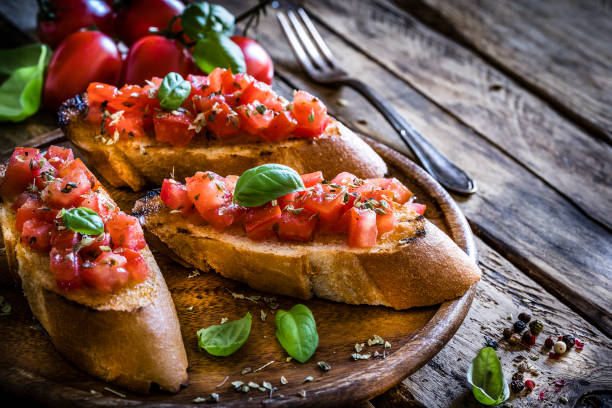 homemade italian bruschetta on rustic wooden table - bruschetta stock pictures, royalty-free photos & images