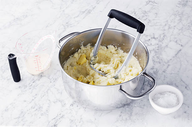 potato masher in pot - making mashed potatoes stock pictures, royalty-free photos & images