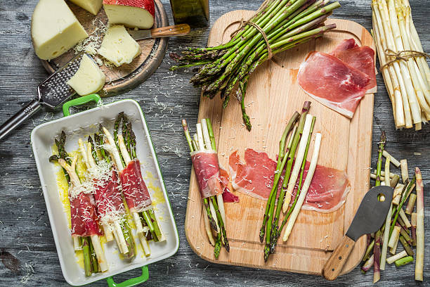 preparations for the casserole with asparagus and cheese - prosciutto wrapped asparagus stock pictures, royalty-free photos & images