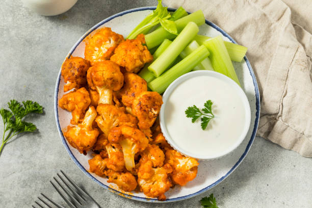 roasted homemade baked buffalo cauliflower wings - buffalo cauliflower stock pictures, royalty-free photos & images