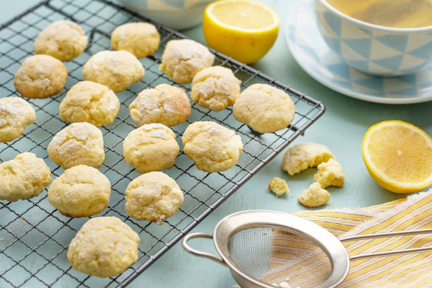 lemon crinkle biscuits cookies with powdered sugar - lemon cookies baking stock pictures, royalty-free photos & images