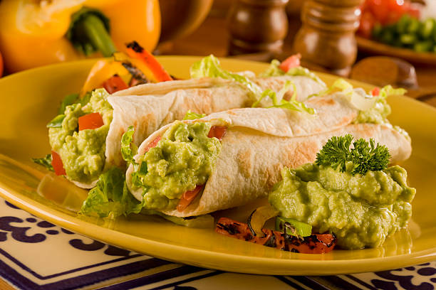 guacamole burrito - guacamole on burrito stock pictures, royalty-free photos & images